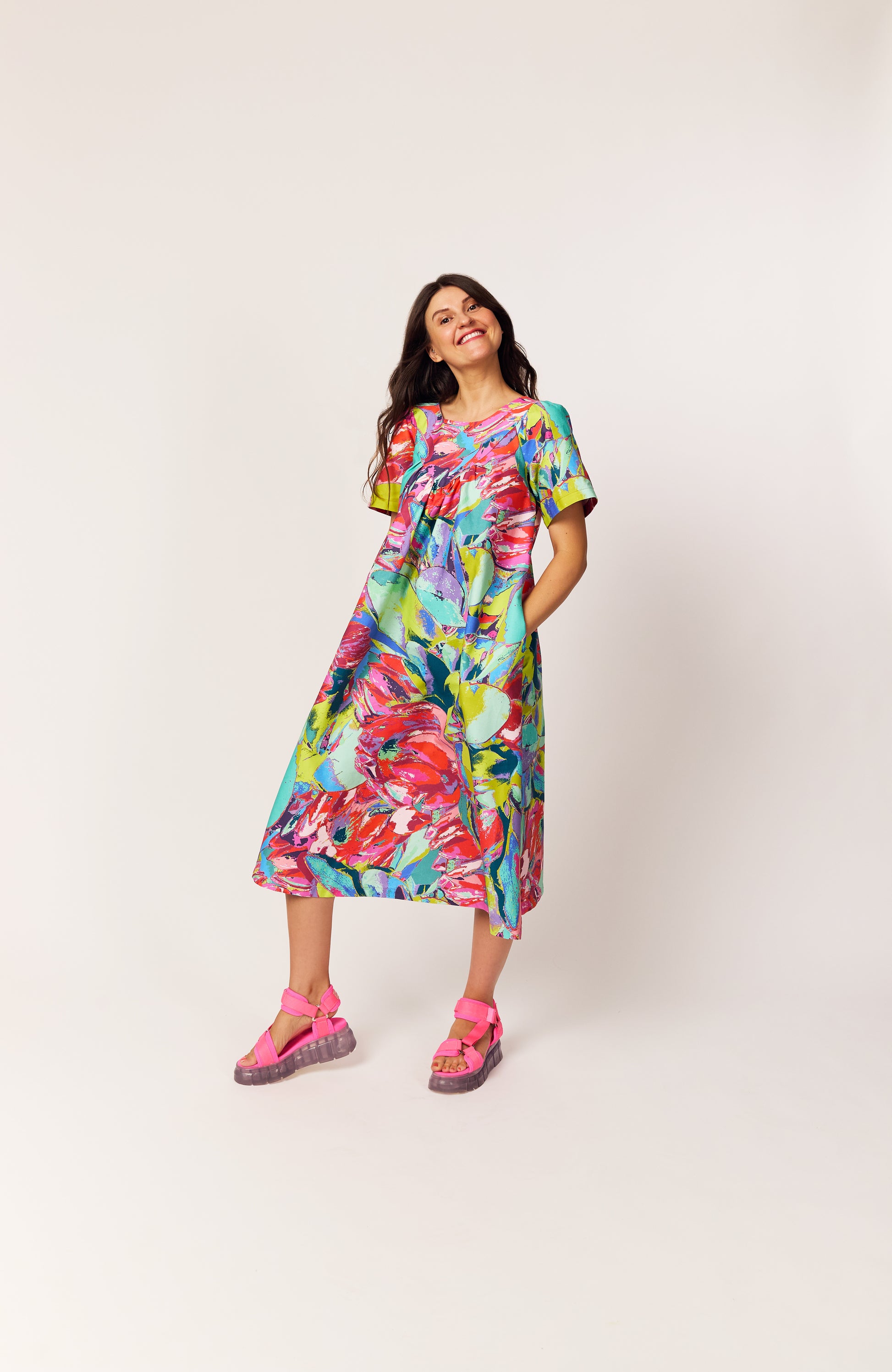 Lanya wearing JOY with The Debut Dress in the Protea Painterly print – sustainable floral midi dress with roomy pockets.