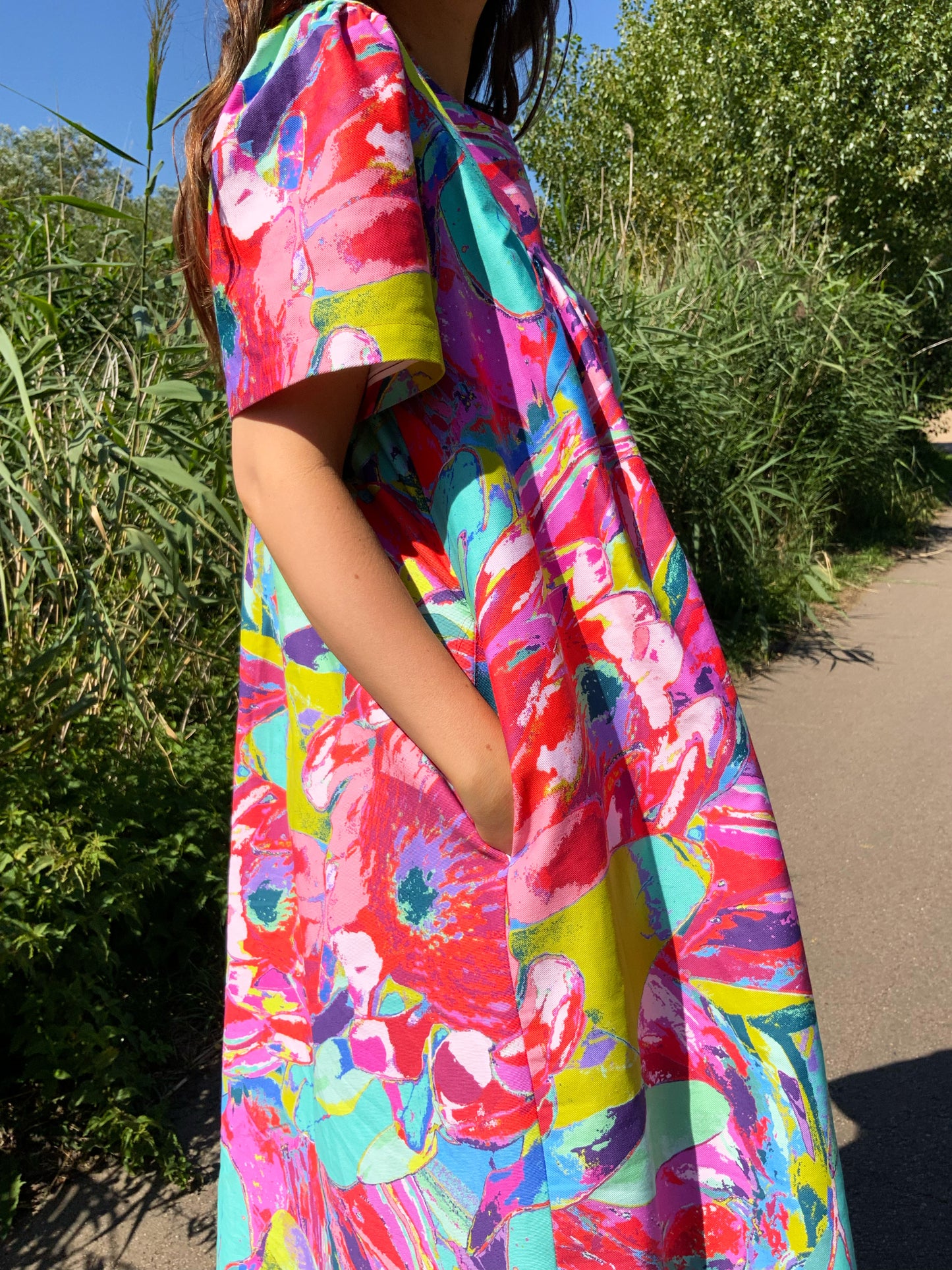 Close-up of pockets and side angle The  Debut Dress by LANYA studio in the Protea Painterly print– bold pink, green and turquoise brushstrokes on premium organic cotton.