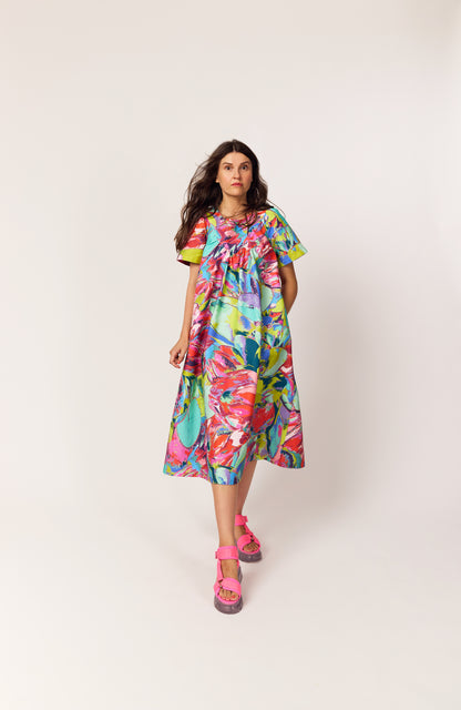 Lanya wearing The Debut Dress in Protea Painterly print – colourful maximal organic cotton midi dress with vintage inspired practical beautiful easy to wear silhouette.