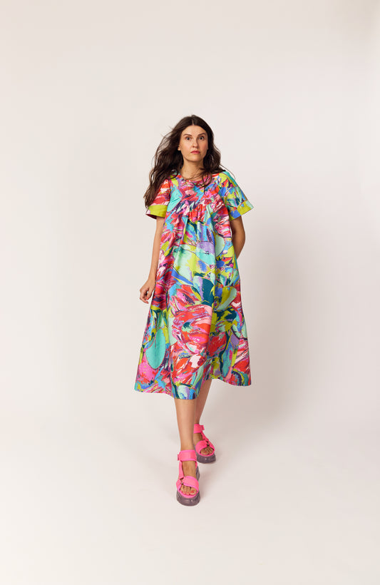 Lanya wearing The Debut Dress in Protea Painterly print – colourful maximal organic cotton midi dress with vintage inspired practical beautiful easy to wear silhouette.